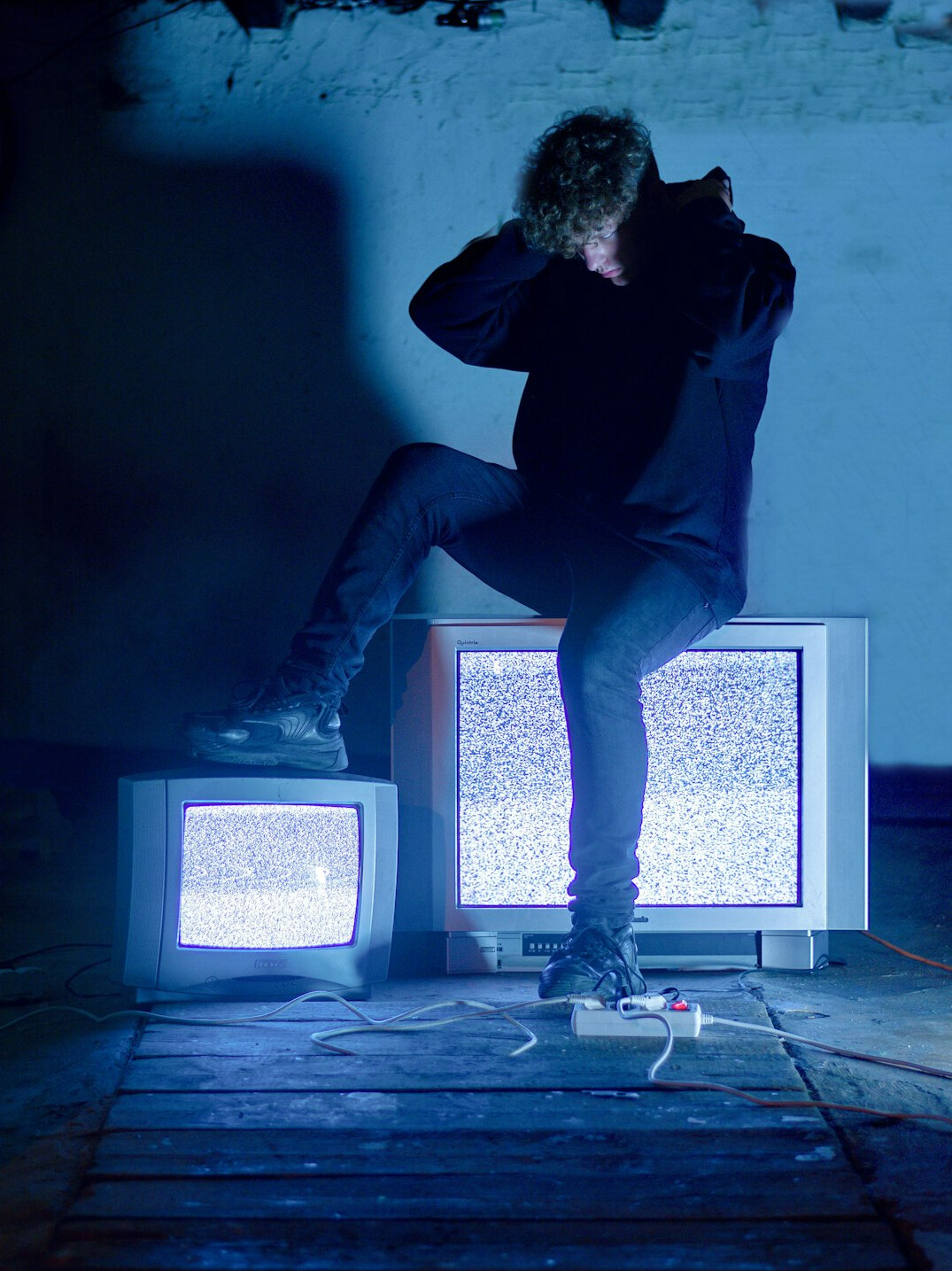 Vintage television set glowing in a dark room